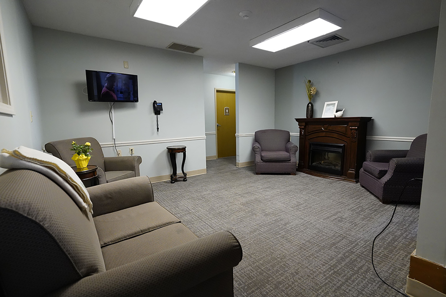 Lobby with sofa and television- Arbors at Carroll