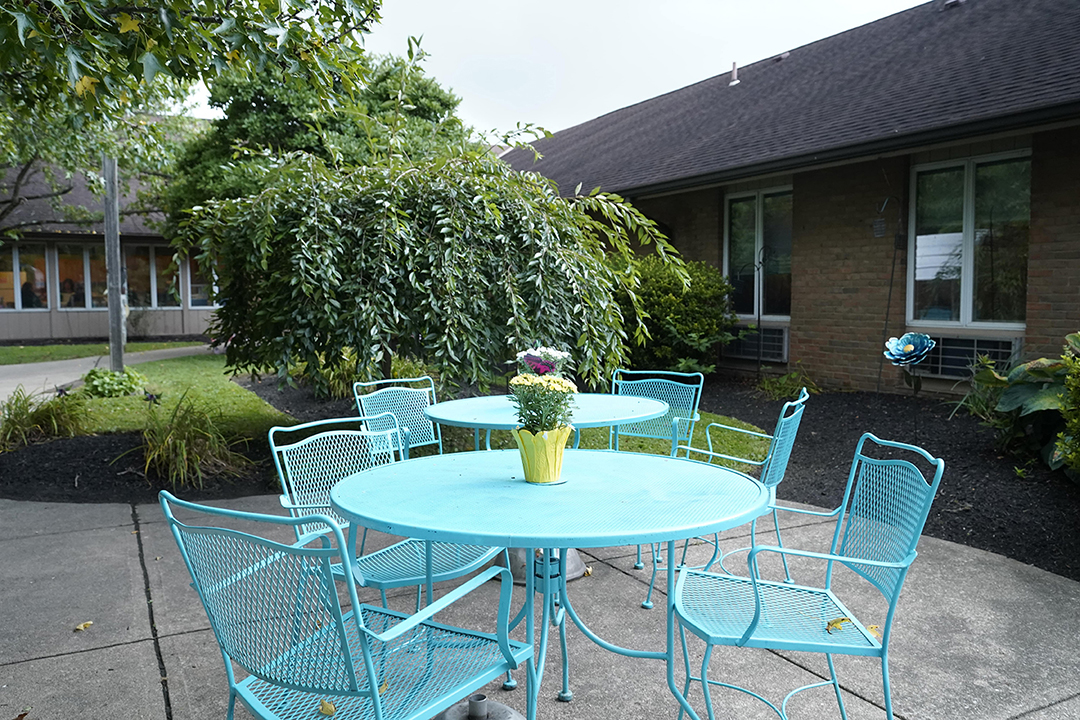 Outdoor Courtyard with table set and flower vase- Arbors at Carroll